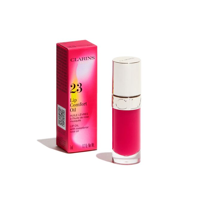 Packshot of the pink Clarins Lip Comfort Oil from the Power of Colors line, displayed alongside its packaging