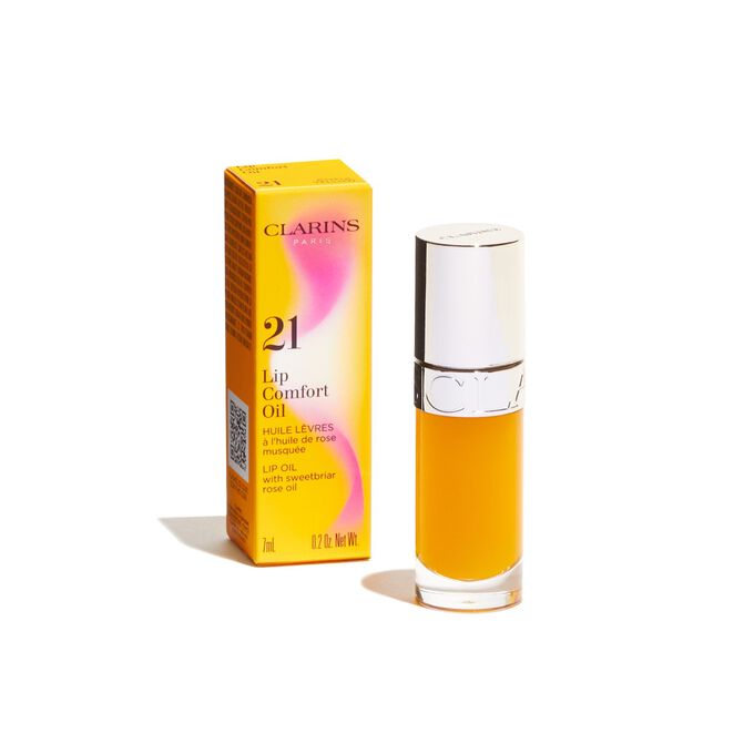 Packshot of the yellow Clarins Lip Comfort Oil from the Power of Colors line, displayed alongside its packaging
